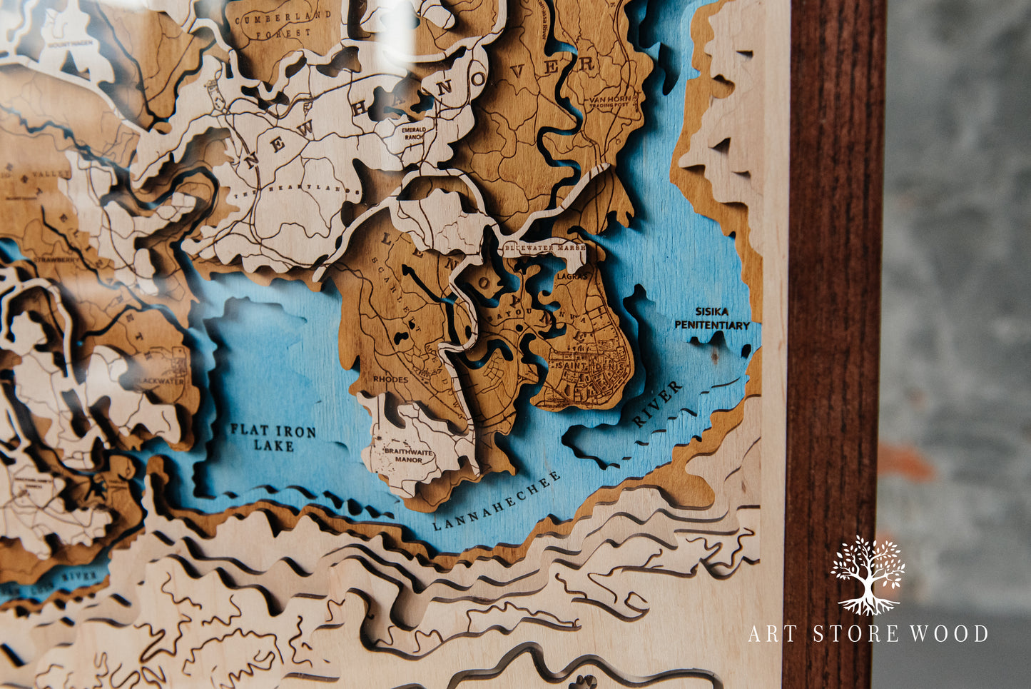 Close-up laser-cut detail on Wild West wooden map showing layered terrain