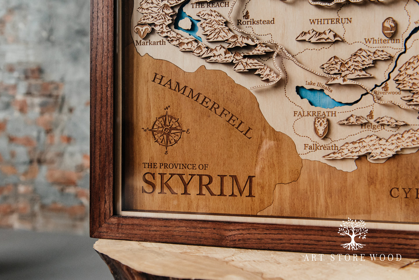 Close-up laser-cut detail of Skyrim wooden map showing terrain and cities