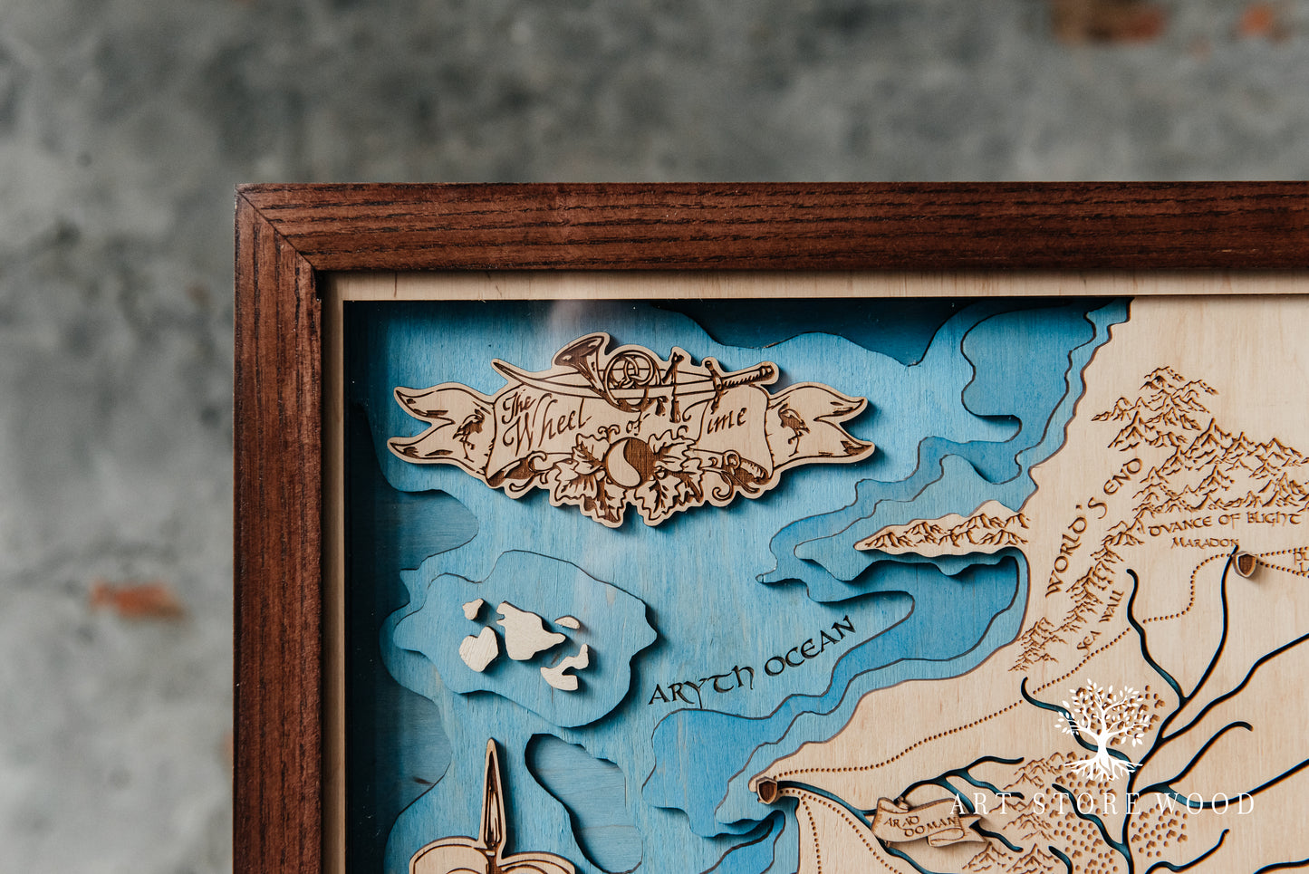 Close-up laser-cut detail on The Wheel of Time 3D wooden map showing terrain layers