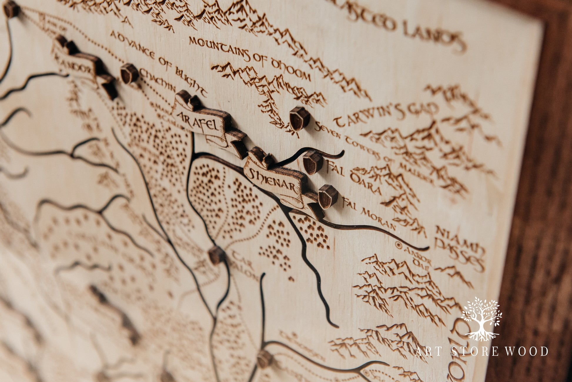 Close-up texture of rivers and mountains on The Wheel of Time 3D wooden map
