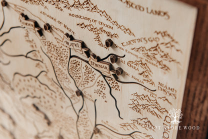 Close-up texture of rivers and mountains on The Wheel of Time 3D wooden map